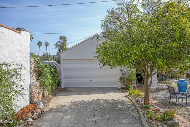 detached garage featuring fence