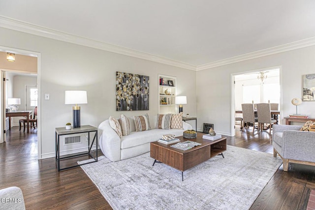 living area with ornamental molding, dark wood-type flooring, and baseboards