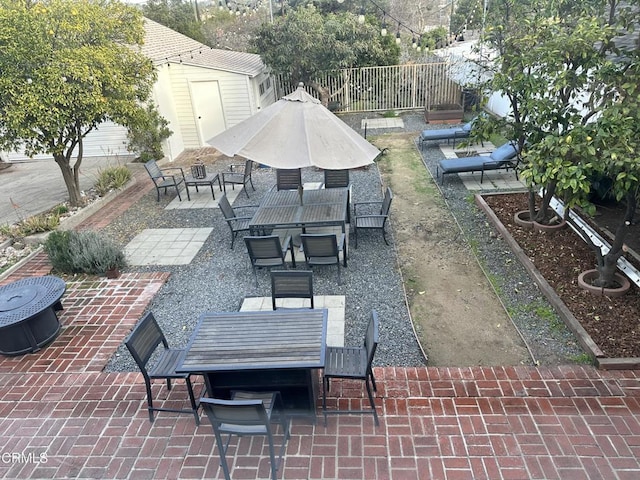 view of patio with fence and outdoor dining space