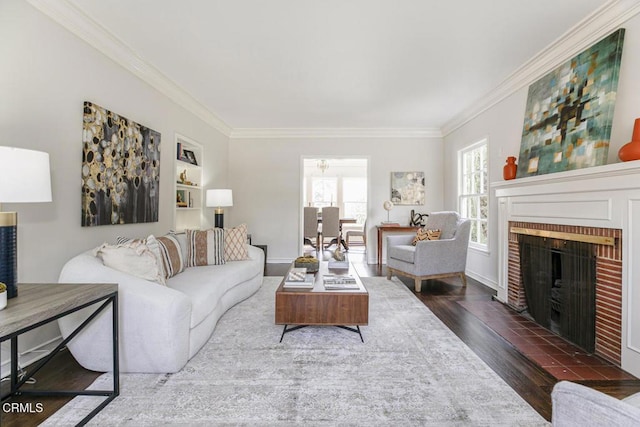 living room with a brick fireplace, dark wood finished floors, and crown molding