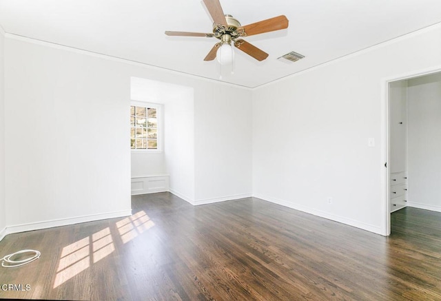 unfurnished room featuring baseboards, visible vents, ceiling fan, and dark wood-style flooring