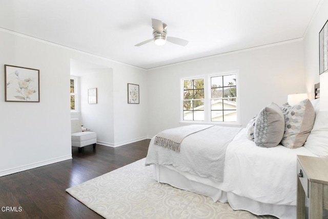 bedroom with ornamental molding, dark wood finished floors, baseboards, and ceiling fan