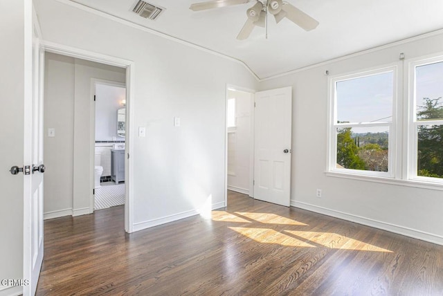 spare room with baseboards, visible vents, and dark wood finished floors