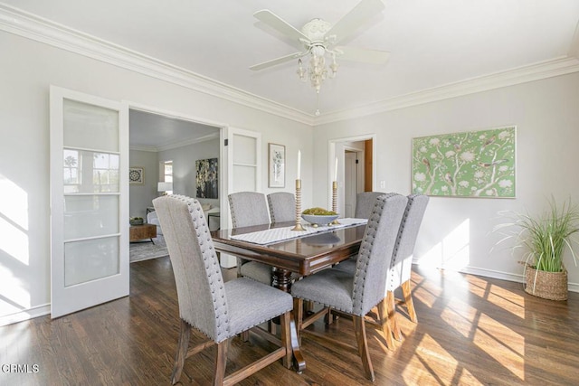 dining area featuring crown molding, dark wood finished floors, baseboards, and a ceiling fan