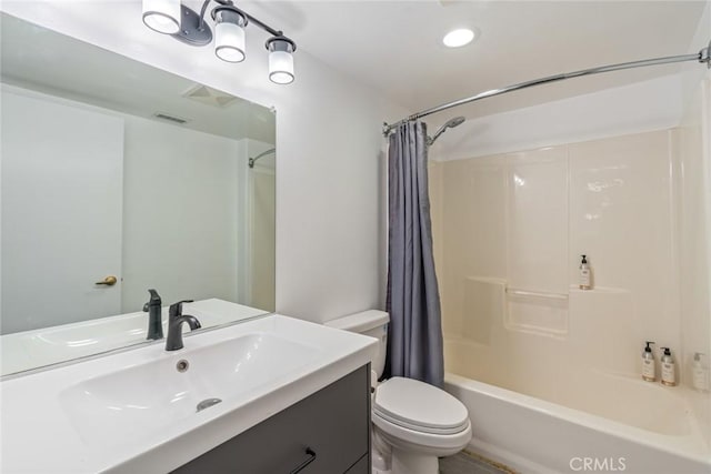 bathroom with visible vents, vanity, toilet, and shower / tub combo