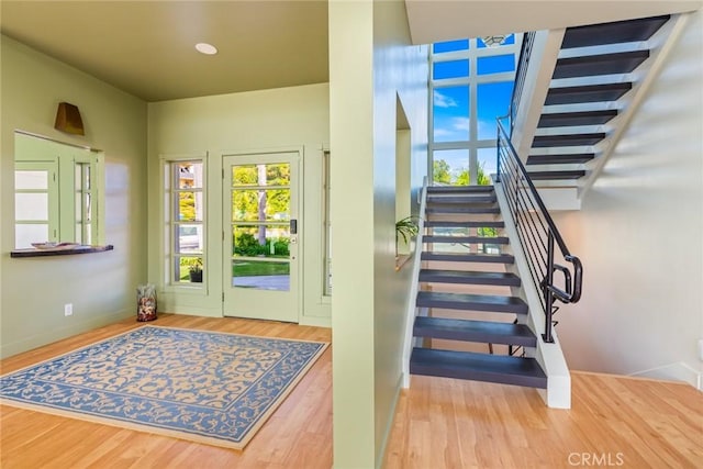 stairs featuring baseboards and wood finished floors