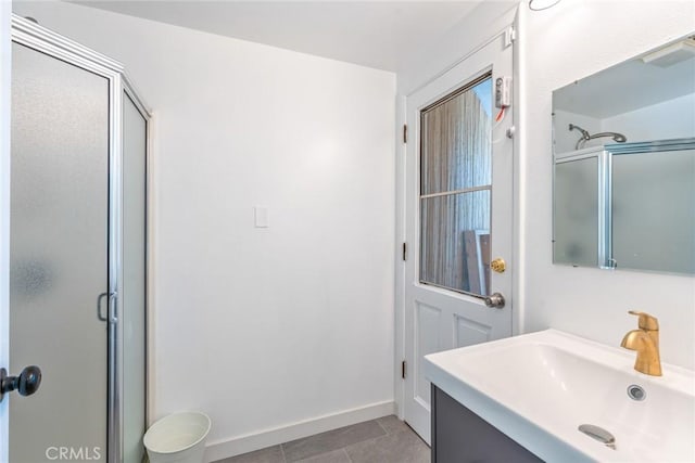 bathroom with tile patterned flooring, a stall shower, and baseboards