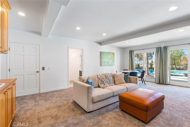 living room featuring recessed lighting, beamed ceiling, and light colored carpet