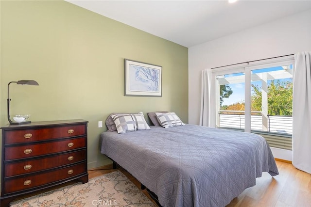 bedroom with baseboards and light wood-type flooring