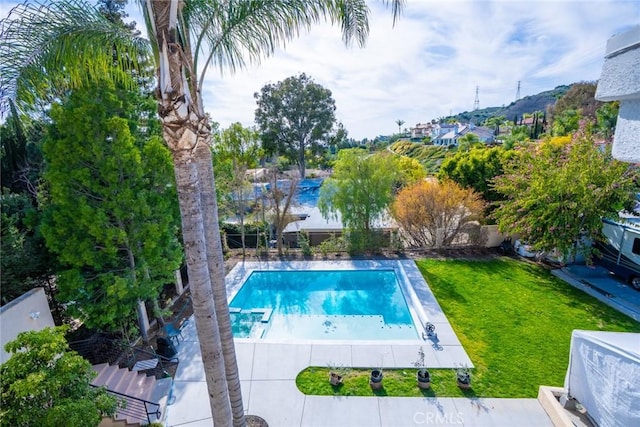 outdoor pool featuring a fenced backyard and a yard