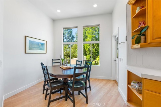 dining area with recessed lighting, baseboards, and light wood finished floors