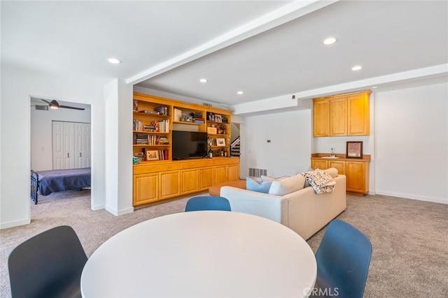 living area featuring recessed lighting, light colored carpet, stairway, and visible vents