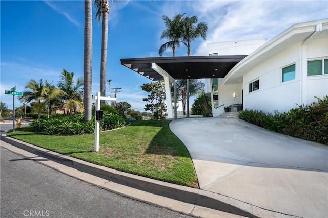 exterior space with a front lawn and stucco siding