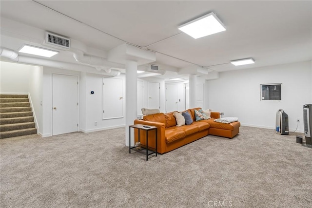 carpeted living room featuring visible vents, baseboards, and stairway