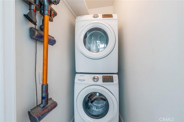 laundry room with stacked washer and clothes dryer and laundry area