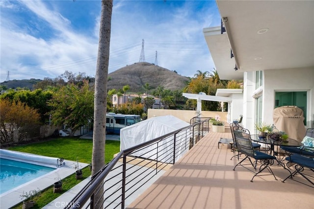 deck featuring a lawn and a mountain view