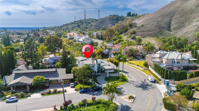 birds eye view of property featuring a mountain view and a residential view