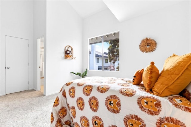 bedroom with vaulted ceiling and carpet flooring