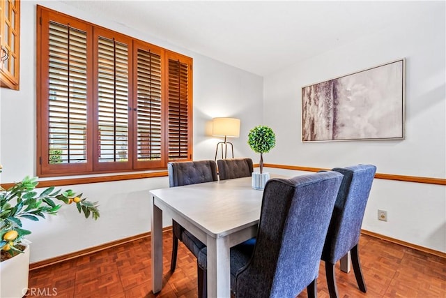 dining space featuring baseboards