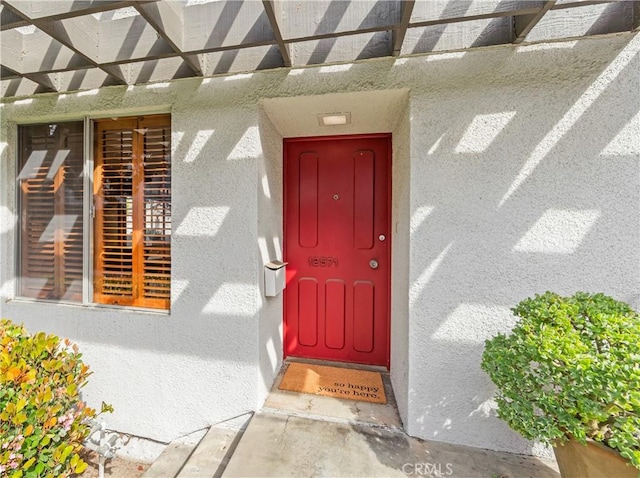 doorway to property with stucco siding