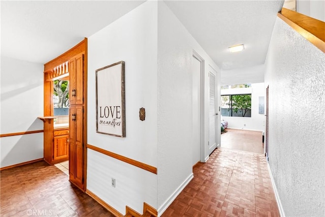 hallway featuring baseboards