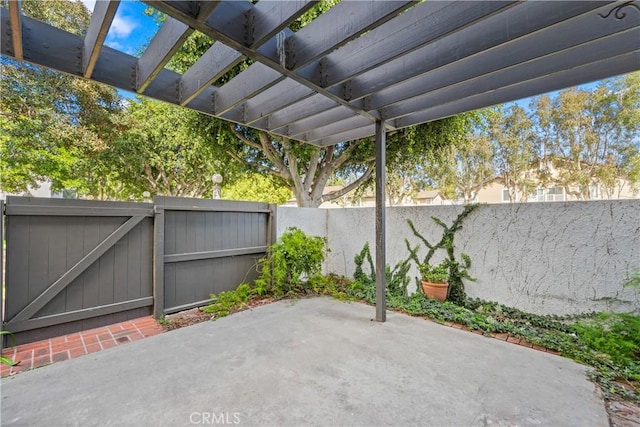 view of patio featuring a fenced backyard, a pergola, and a gate