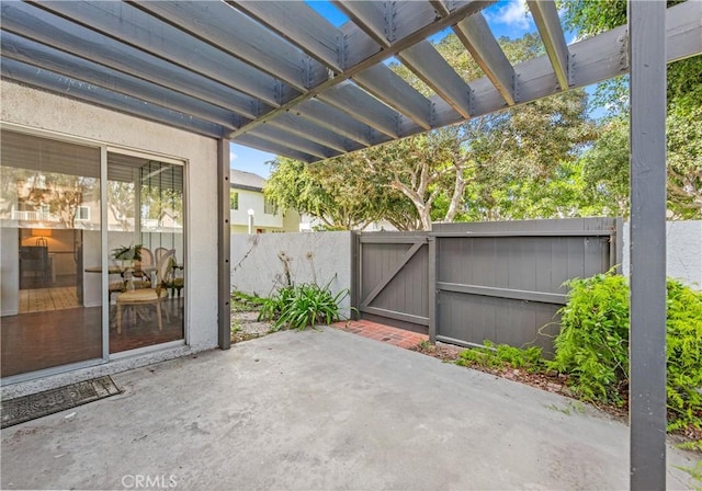 view of patio / terrace featuring a gate, a pergola, and fence