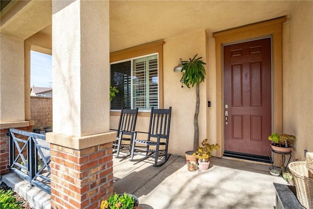 view of exterior entry with a porch