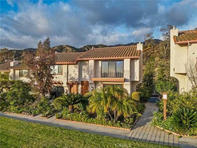 mediterranean / spanish house with a mountain view and a balcony