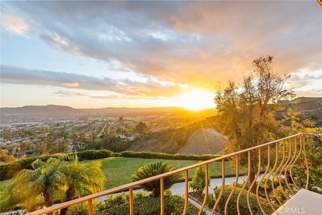 balcony at dusk with a water and mountain view