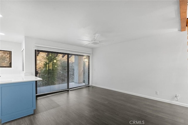 empty room featuring dark hardwood / wood-style flooring and ceiling fan