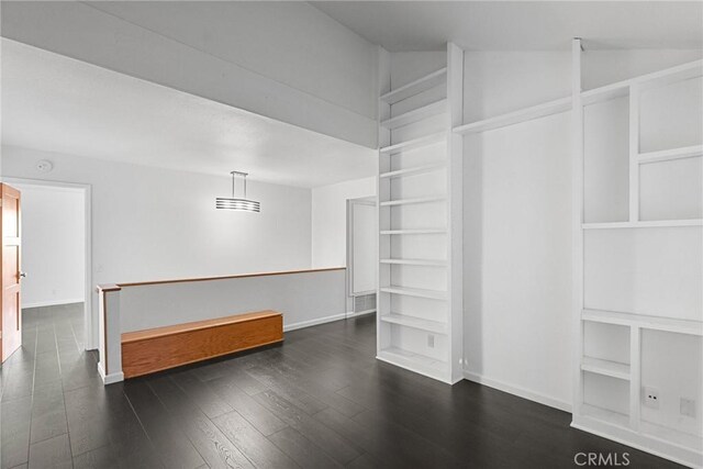 interior space with lofted ceiling and dark hardwood / wood-style flooring