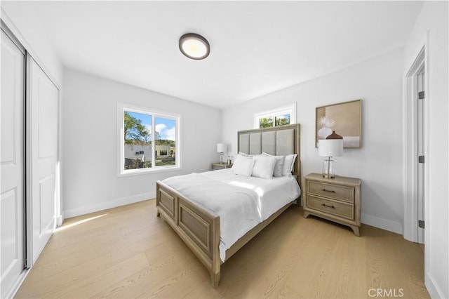 bedroom featuring light wood-type flooring and a closet