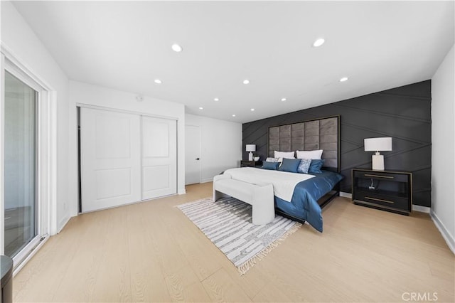 bedroom featuring light hardwood / wood-style flooring and a closet