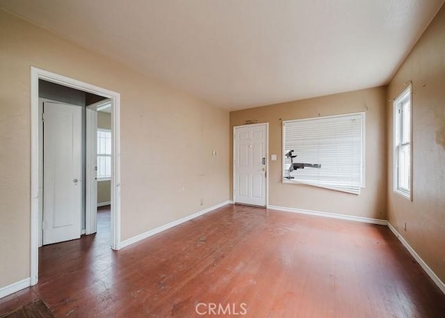 interior space with baseboards and wood finished floors