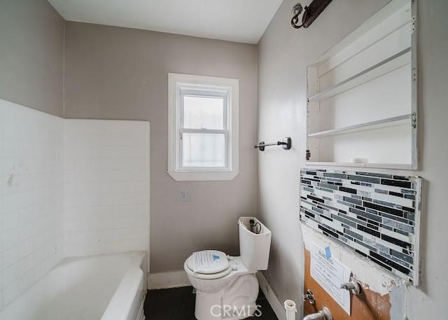 full bath with toilet and baseboards