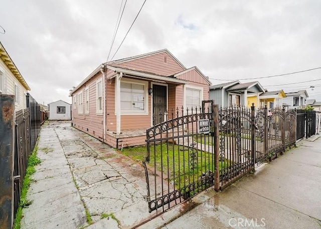 shotgun-style home featuring a fenced front yard
