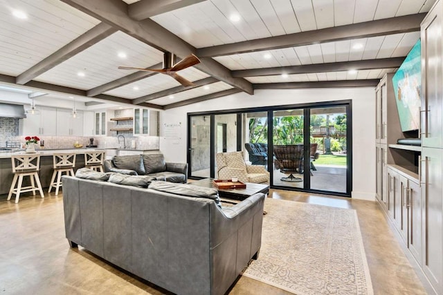 living room with ceiling fan, vaulted ceiling with beams, wooden ceiling, and sink