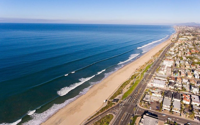 birds eye view of property with a beach view and a water view