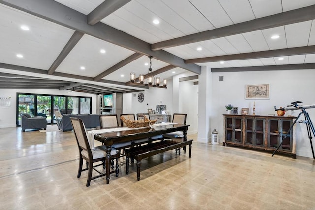 dining room featuring vaulted ceiling with beams