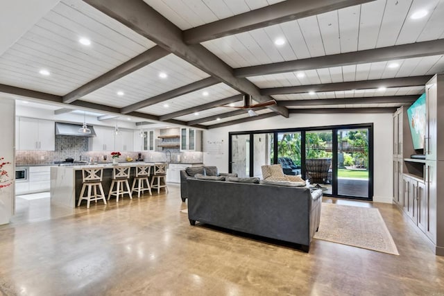 living room featuring vaulted ceiling with beams