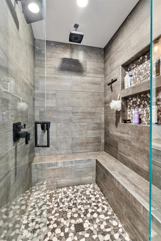 bathroom with tiled shower