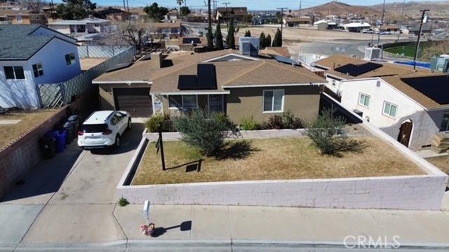 view of front of property with a garage, aphalt driveway, a residential view, and stucco siding