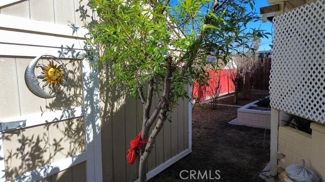 view of side of property featuring fence