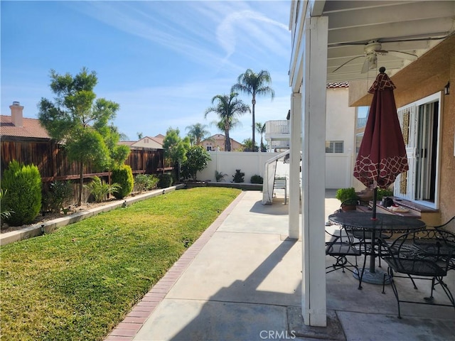 view of yard with a patio area and ceiling fan