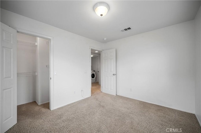40241 Courtland Way, Temecula, CA 92591 - unfurnished bedroom featuring washer / clothes dryer, light carpet, and a closet