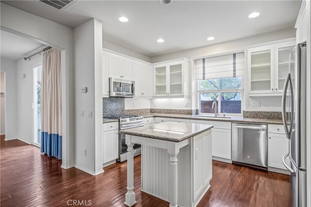 40241 Courtland Way, Temecula, CA 92591 - kitchen featuring a breakfast bar, white cabinetry, a kitchen island, stainless steel appliances, and light stone countertops