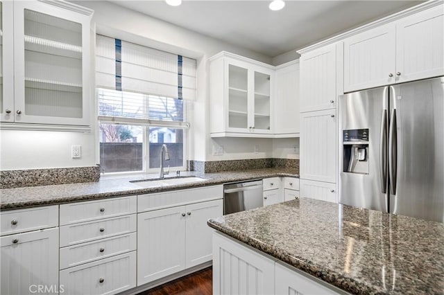 40241 Courtland Way, Temecula, CA 92591 - kitchen with appliances with stainless steel finishes, sink, dark stone counters, dark wood-type flooring, and white cabinets