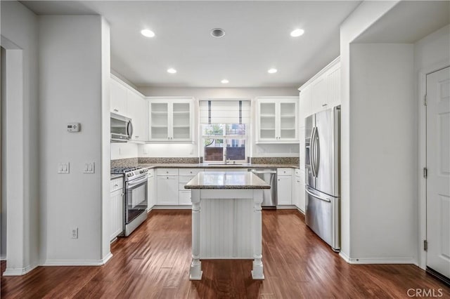 40241 Courtland Way, Temecula, CA 92591 - kitchen featuring white cabinetry, stainless steel appliances, a center island, light stone countertops, and dark hardwood / wood-style floors