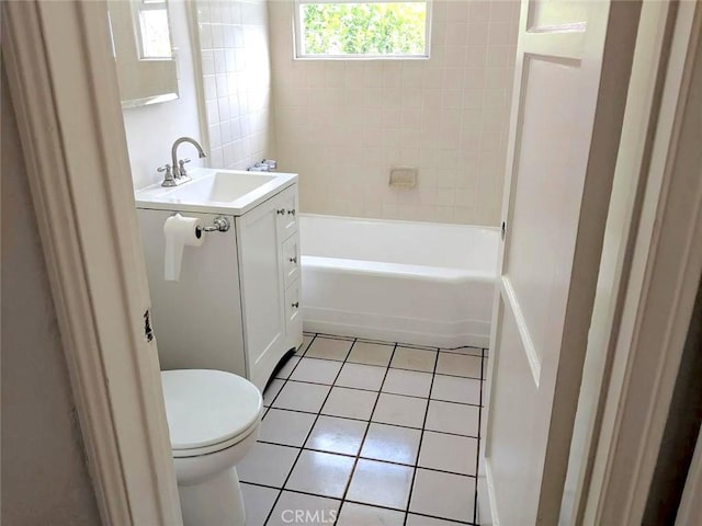 full bathroom with tiled shower / bath combo, vanity, tile patterned flooring, and toilet